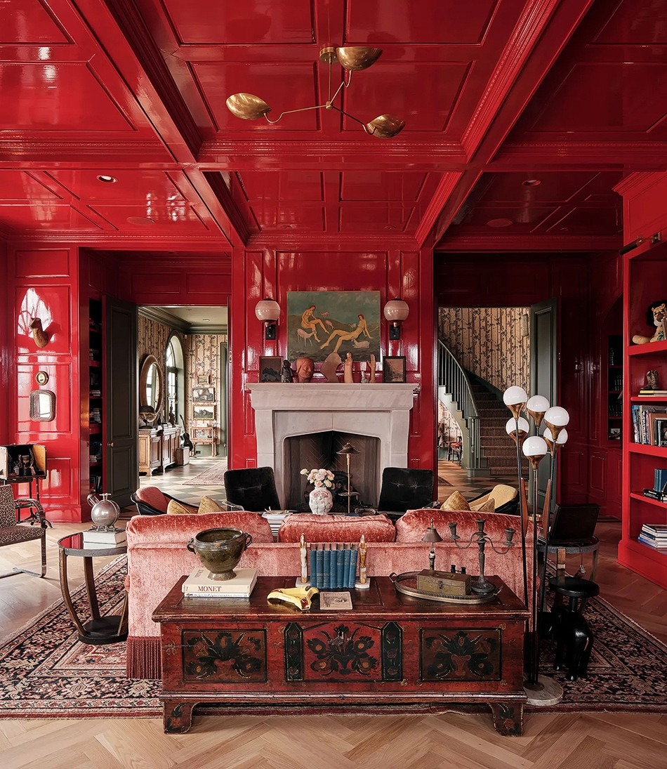 17. High-Gloss Red Paneled Living Room with Classic Fireplace - red living room ideas