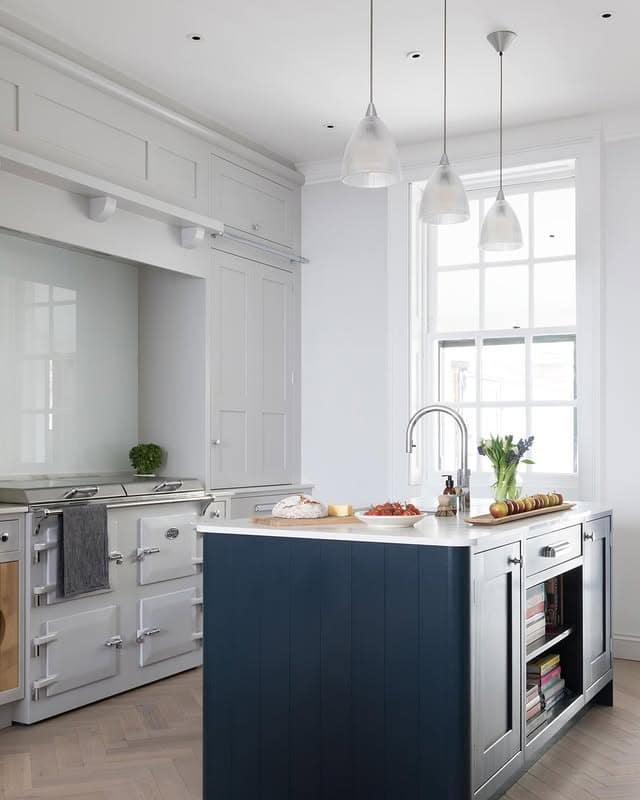 4. Deep Blue Island with Crisp White Framed Cabinetry - blue and gray kitchen ideas