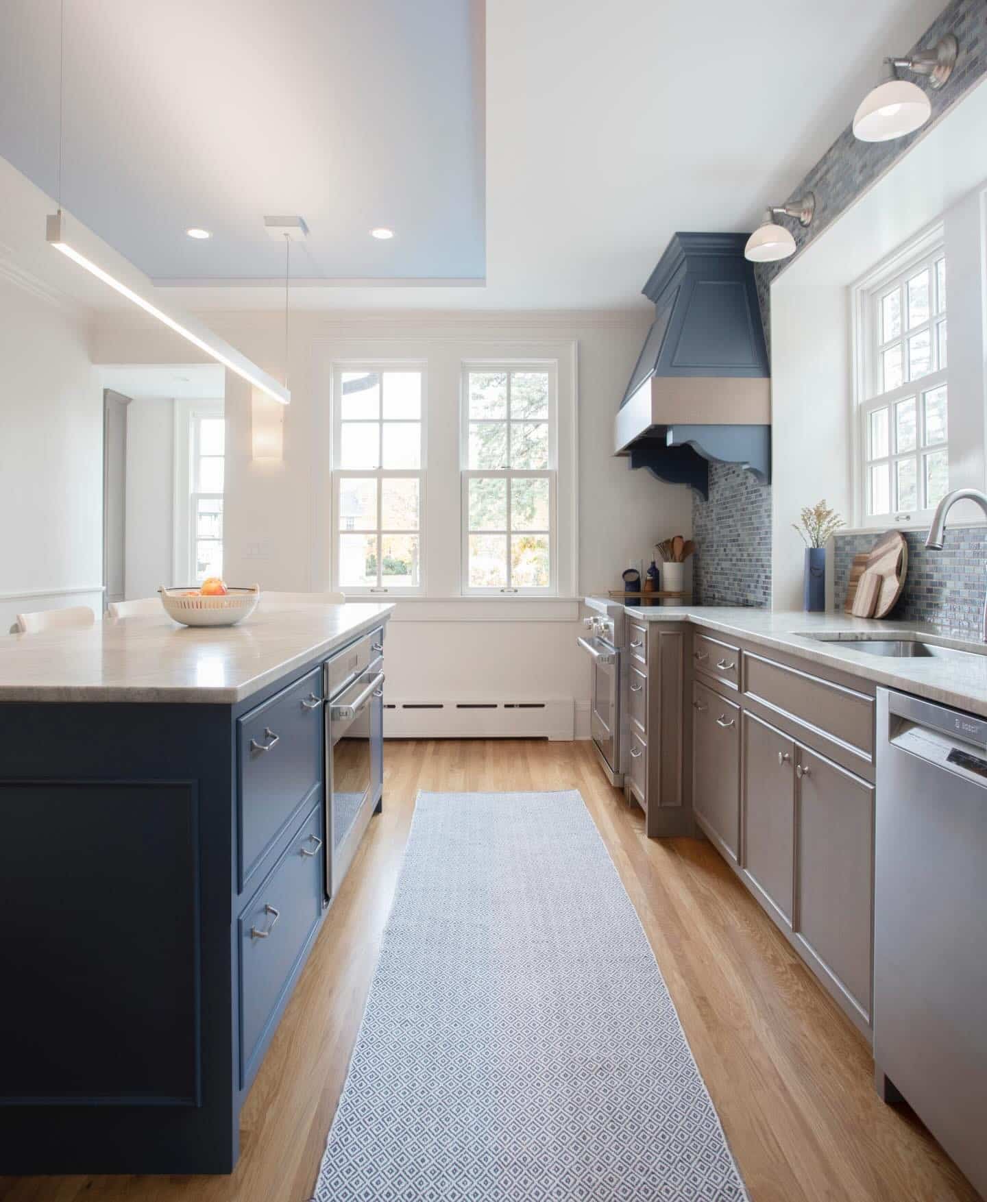 11. Navy Blue Island with Warm Gray Cabinetry and Natural Wood Flooring - blue and gray kitchen ideas