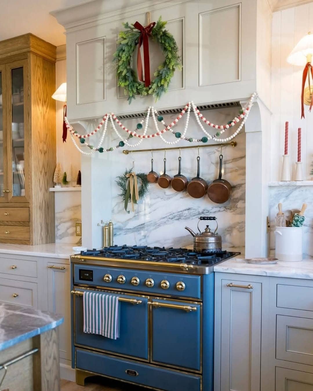 12. Blue Range Feature with Soft Gray Cabinetry and Festive Accents - blue and gray kitchen ideas