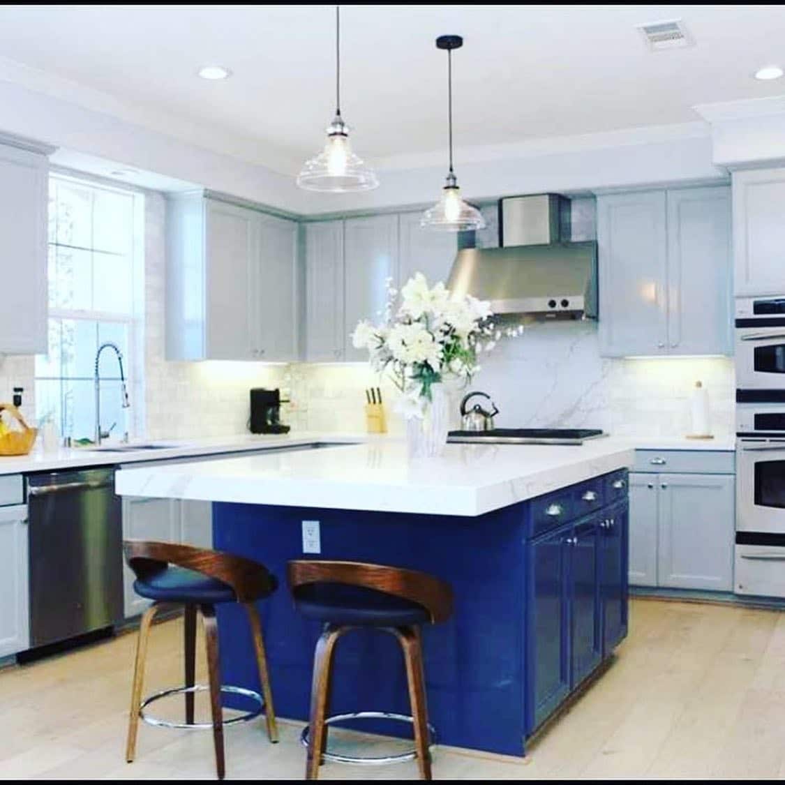 15. Bold Blue Island with Light Gray Cabinetry and Bright White Surfaces - blue and gray kitchen ideas