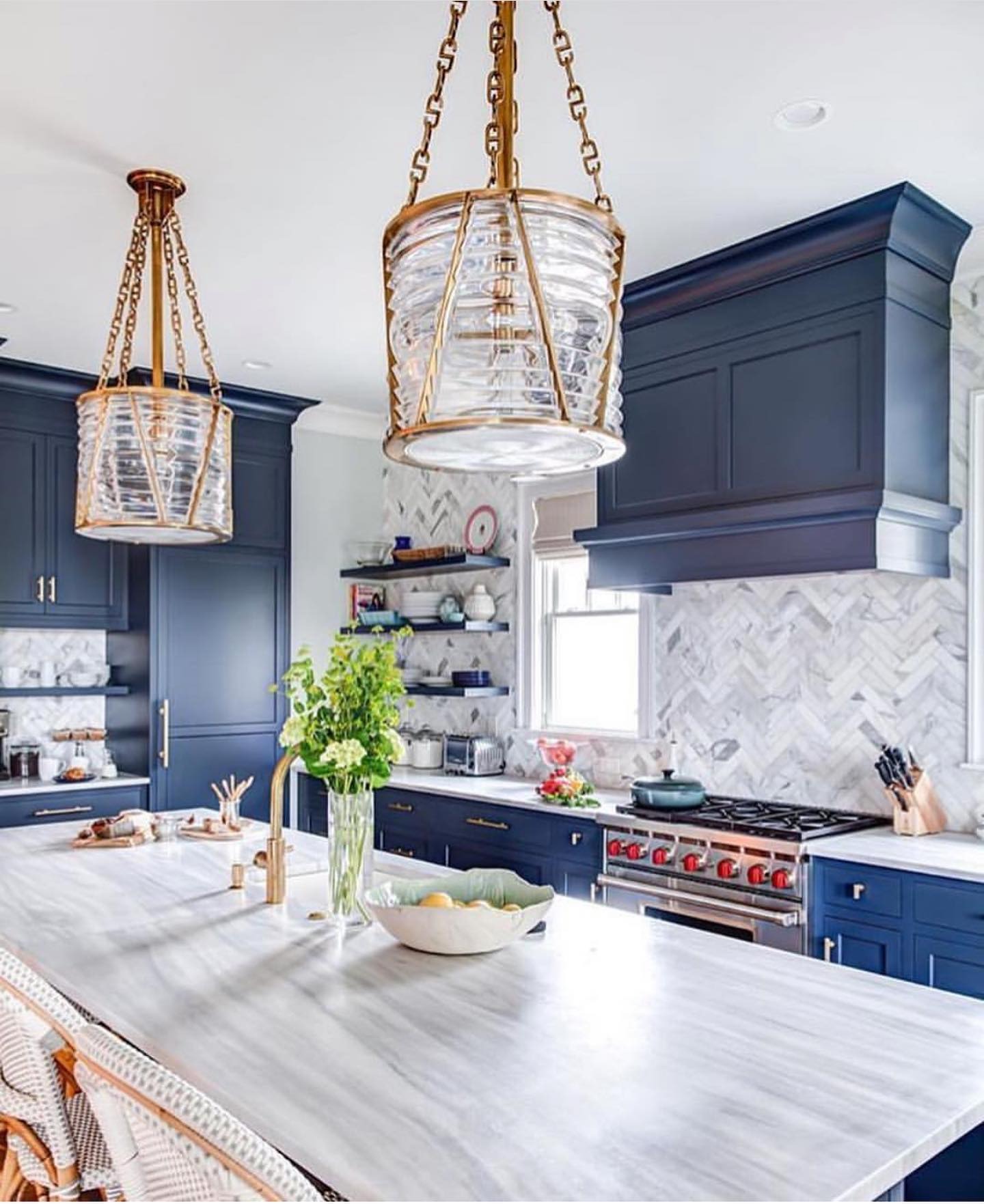 16. Deep Navy Cabinetry with Brass Accents and Marble Backsplash - blue and gray kitchen ideas