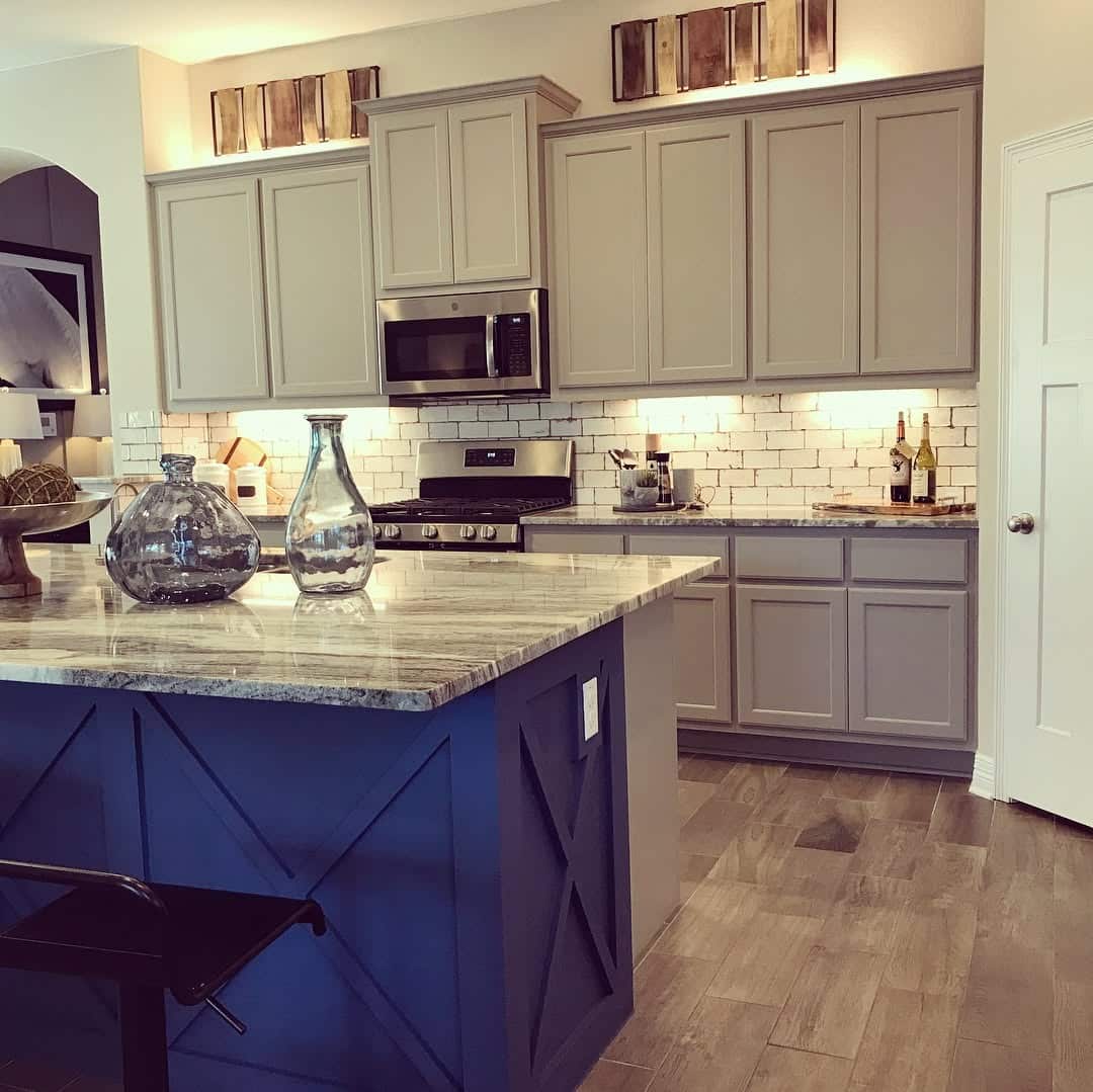 17. Blue Island with Cross-Panel Detailing and Warm Gray Cabinets - blue and gray kitchen ideas
