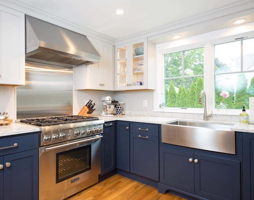 18. Navy Base Cabinets with Crisp White Upper Units and Farmhouse Sink - blue and gray kitchen ideas