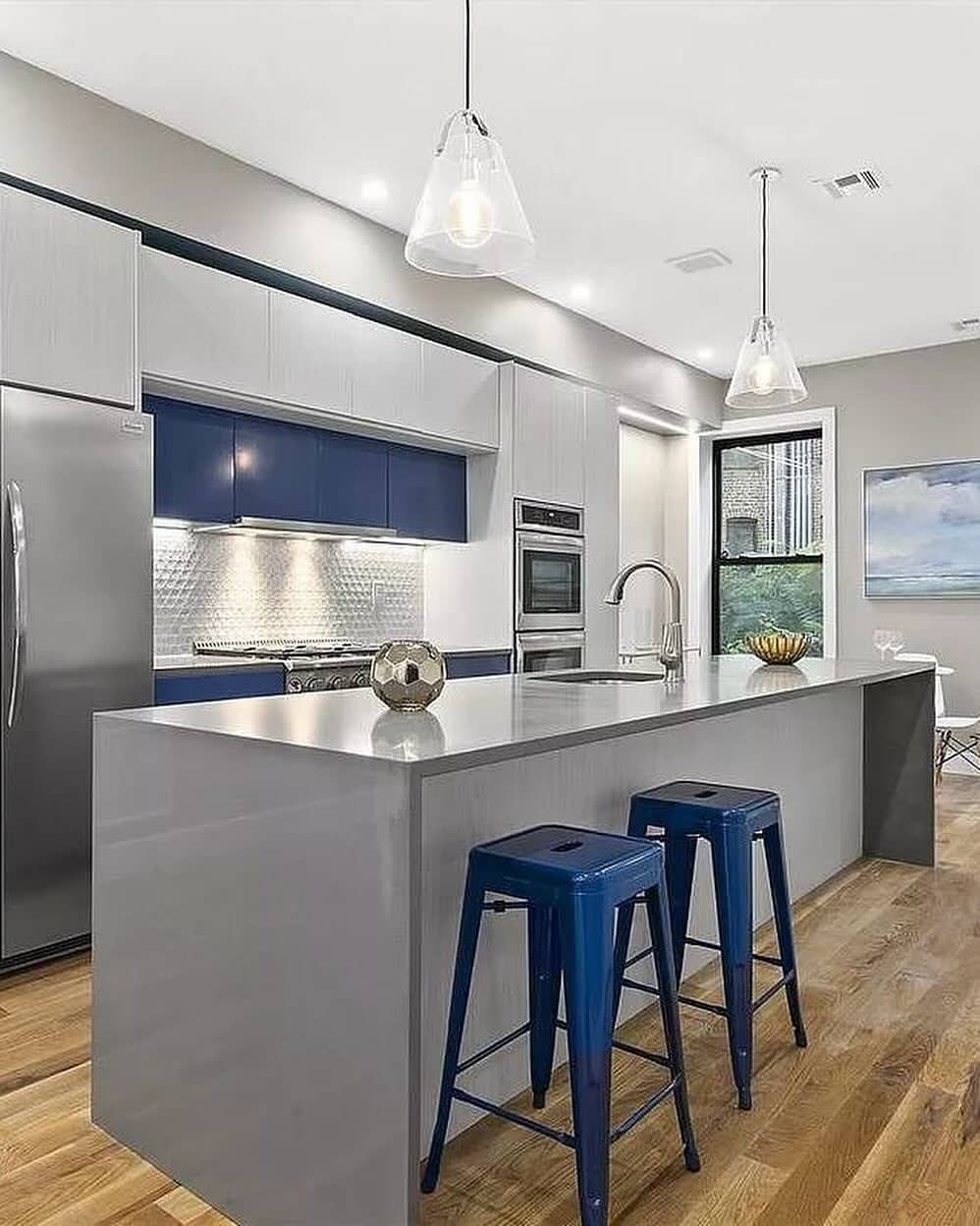 20. Minimalist Blue and Gray Kitchen with Sleek Island and Modern Lighting - blue and gray kitchen ideas