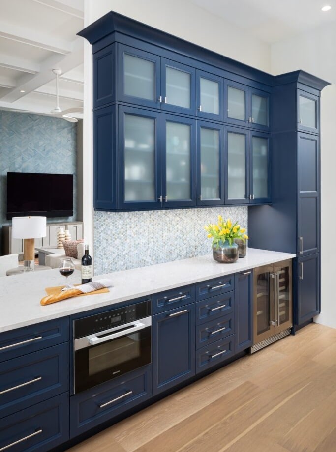 21. Classic Navy Built-In Cabinetry with Frosted Glass Panels and Soft Gray Backsplash - blue and gray kitchen ideas
