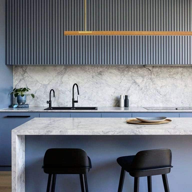 22. Minimalist Blue and Gray Kitchen with Fluted Cabinetry and Marble Surfaces - blue and gray kitchen ideas