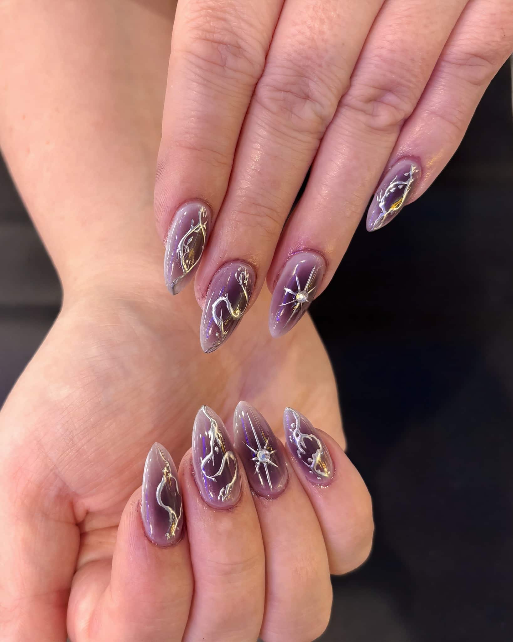 2. Amethyst Marble Stiletto Nails with Metallic Accents - sophisticated nail ideas
