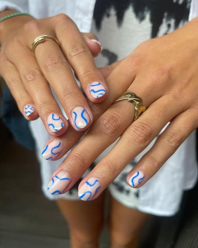 2. Milky Short Nails with Blue Abstract Waves - squiggle nail ideas