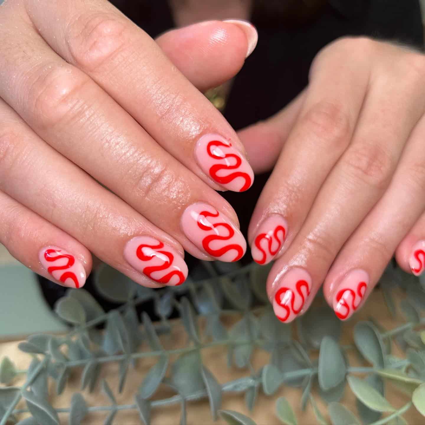 4. Sheer Pink Nails with Bold Red Squiggles - squiggle nail ideas