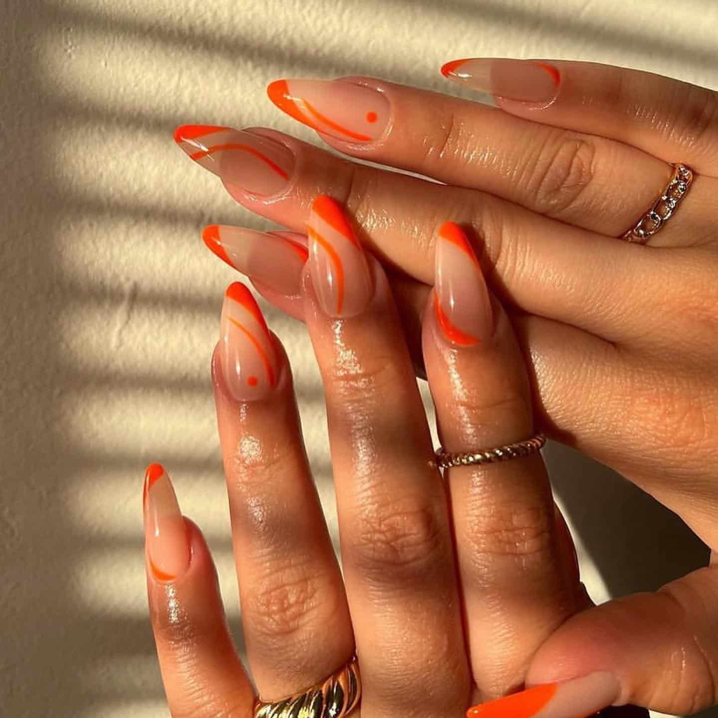 10. Glossy Nude Almond Nails with Neon Orange Squiggles - squiggle nail ideas