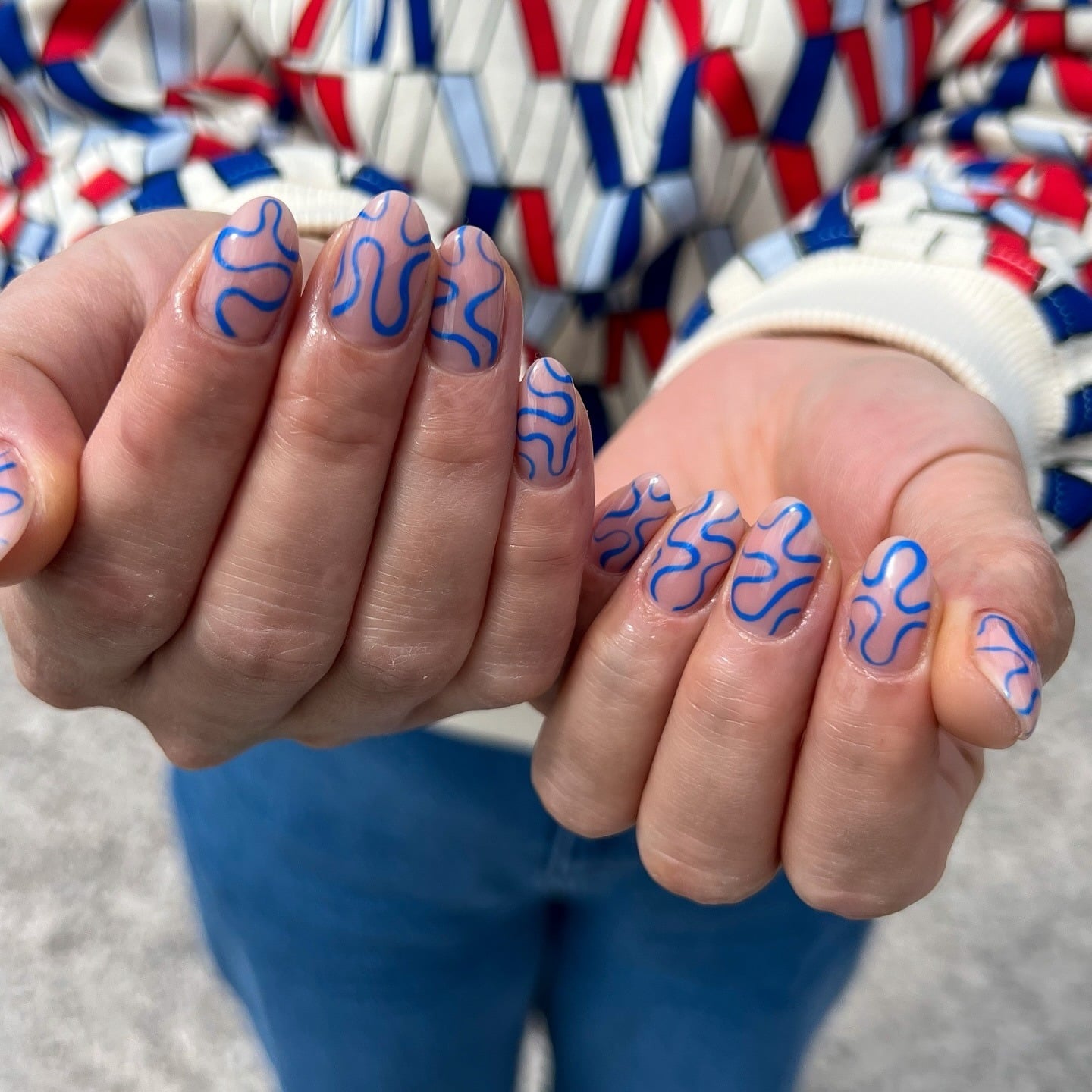 21. Nude Oval Nails with Electric Blue Squiggle Lines - squiggle nail ideas