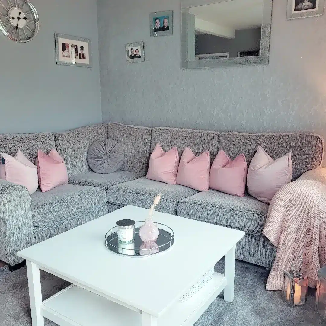 11. Soft Grey Sectional with Blush Cushion Layering - pink and grey living room ideas
