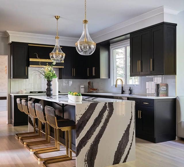 2. Statement Island with Black Cabinetry and White Marble Waterfall - black and white kitchen ideas