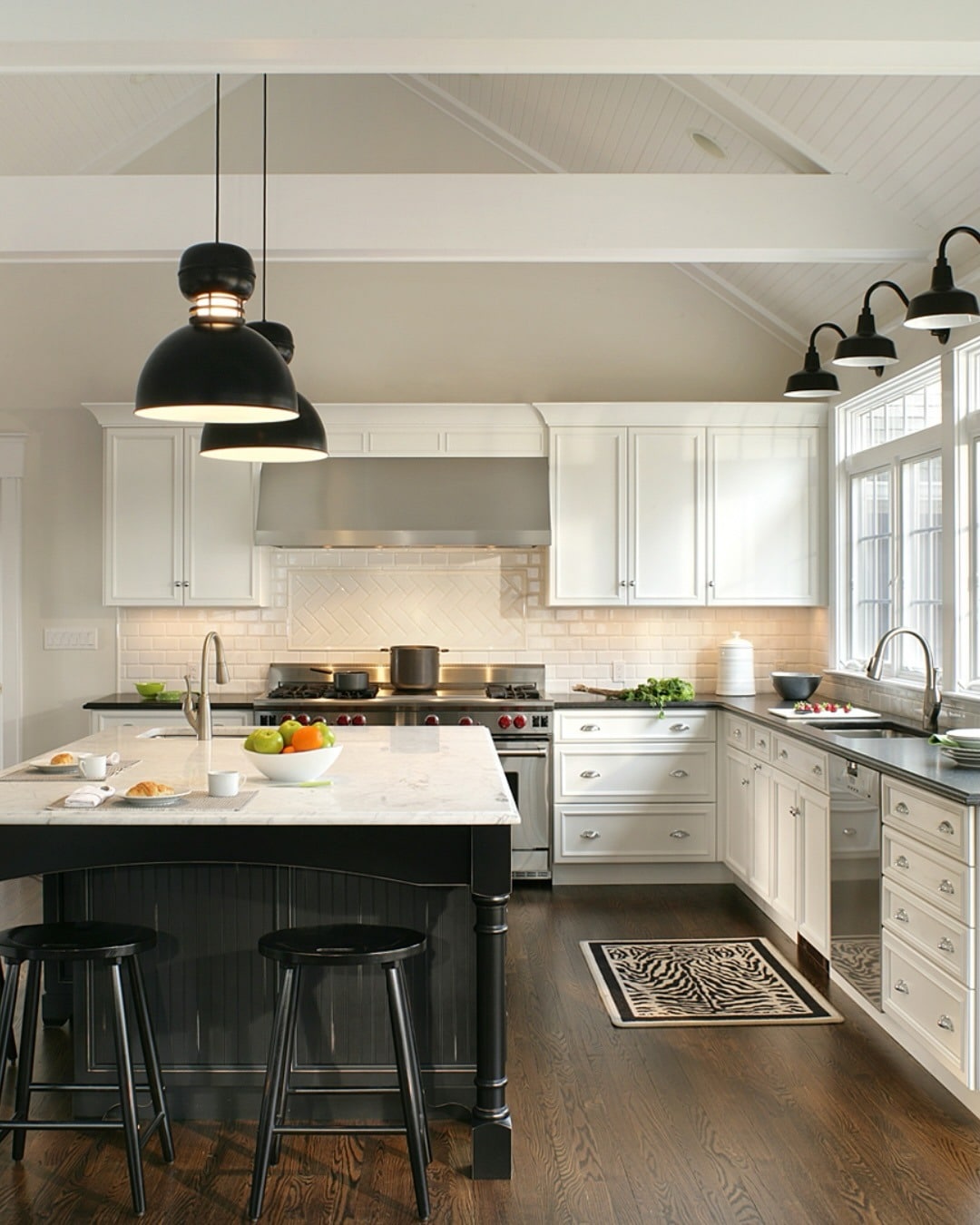 3. Bright Farmhouse Kitchen with Black Island and White Surrounds - black and white kitchen ideas
