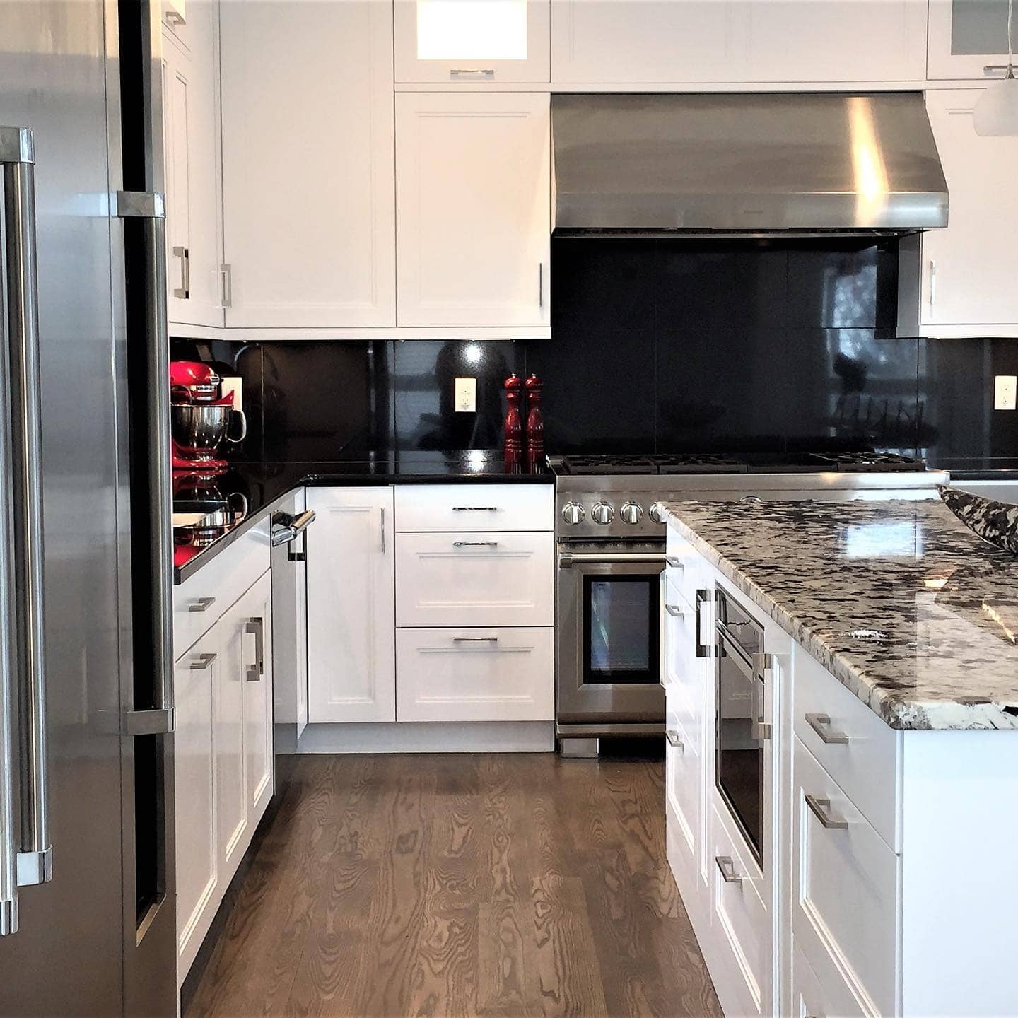 4. Sleek Black Backsplash with White Shaker Cabinets - black and white kitchen ideas