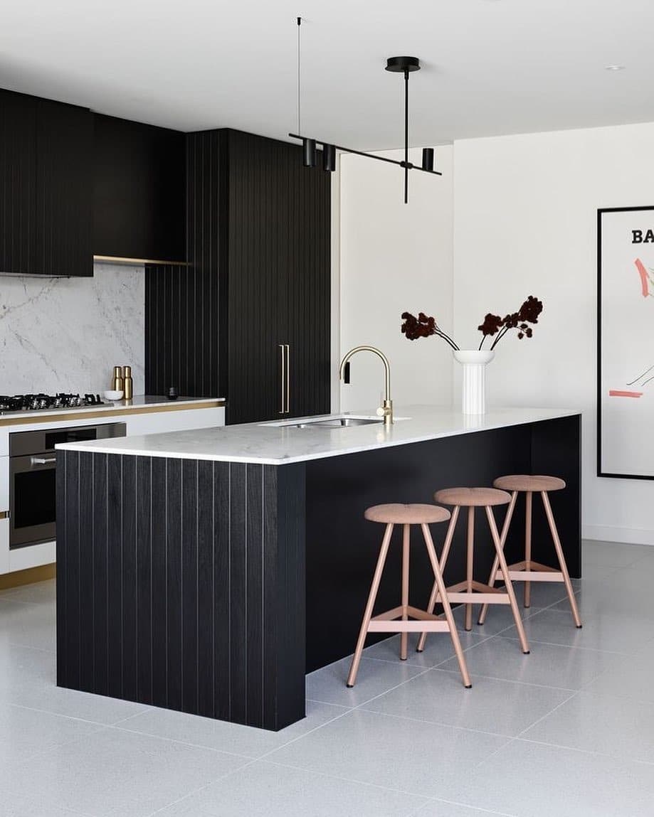 13. Minimalist Black Kitchen with Fluted Island and White Countertop - black and white kitchen ideas