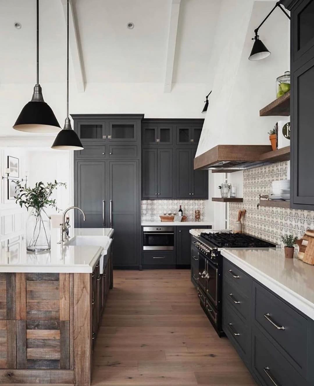 17. Farmhouse-Inspired Kitchen with Black Cabinets and Wood Island - black and white kitchen ideas