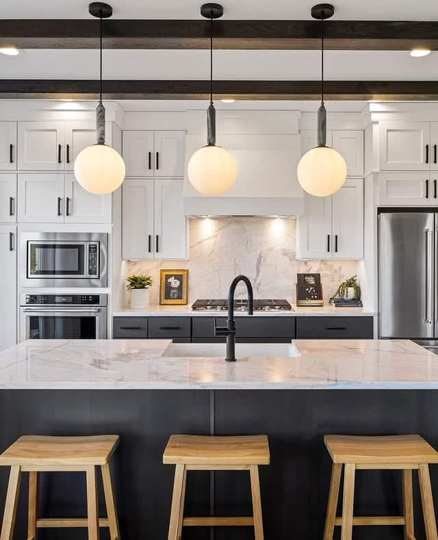 21. Modern Farmhouse Kitchen with Black Island and White Cabinetry - black and white kitchen ideas