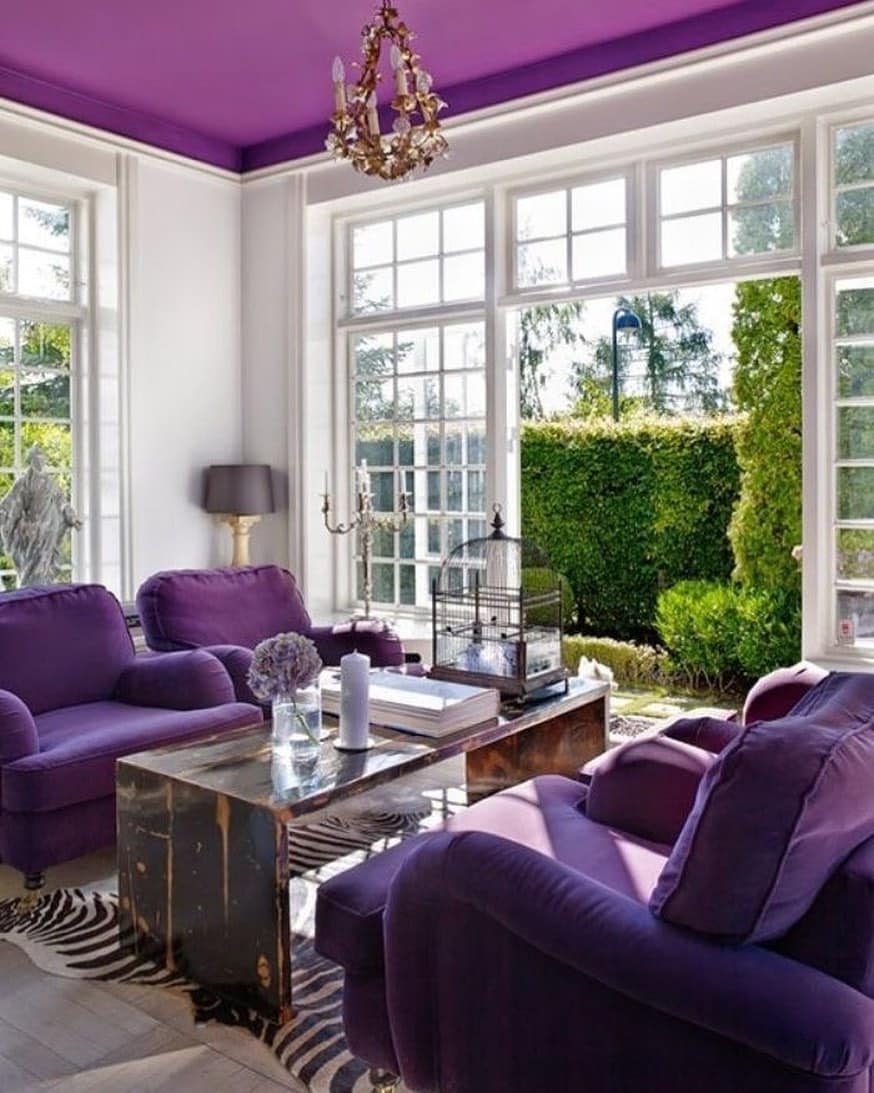 8. Bright Purple Seating with Natural Light Focus - purple living room ideas
