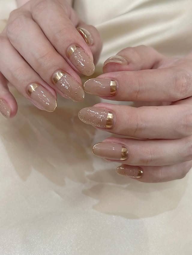 17. Nude Taupe Almond Nails with Gold French Tips - taupe nail ideas