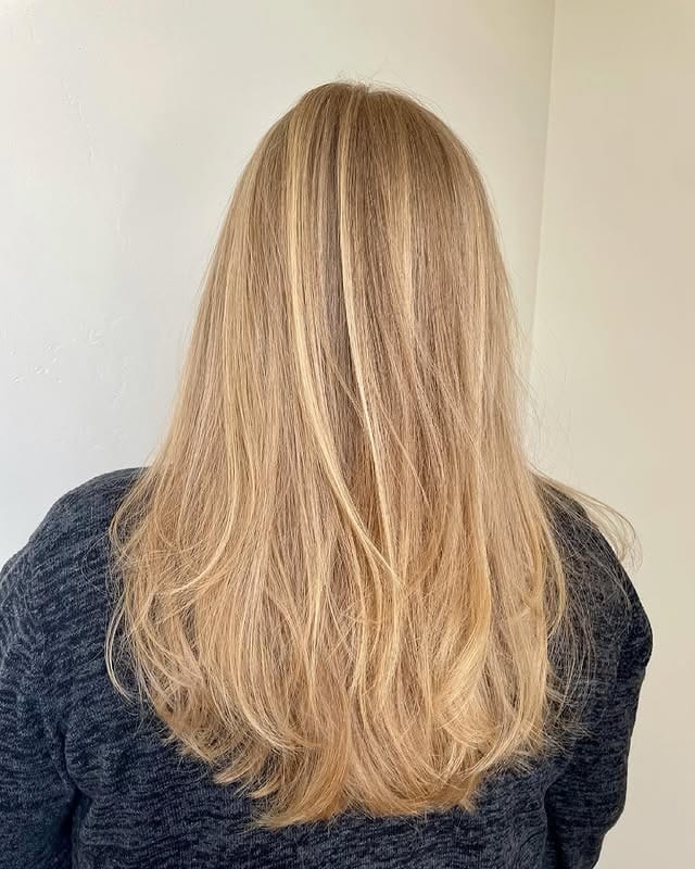 2. Feathered Long Layers in Warm Honey Blonde - Wispy Layered Haircuts