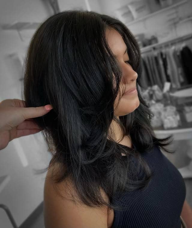4. Voluminous Layered Blowout in Deep Black - Wispy Layered Haircuts