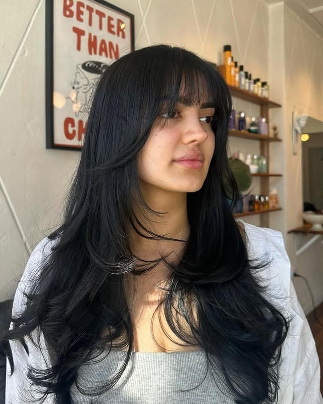 17. Long Flowing Layers with Wispy Bangs in Jet Black - Wispy Layered Haircuts