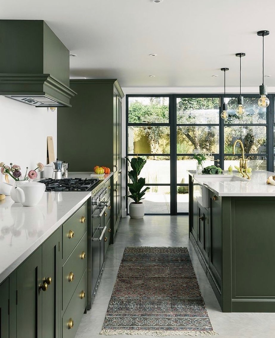 16. Dark Olive Green Kitchen with Statement Range and Rug Accent - olive green kitchen ideas