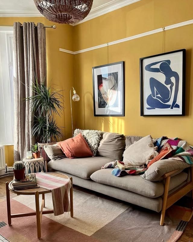1. Soft Mustard Walls with Neutral Sofa Layering - yellow living room ideas