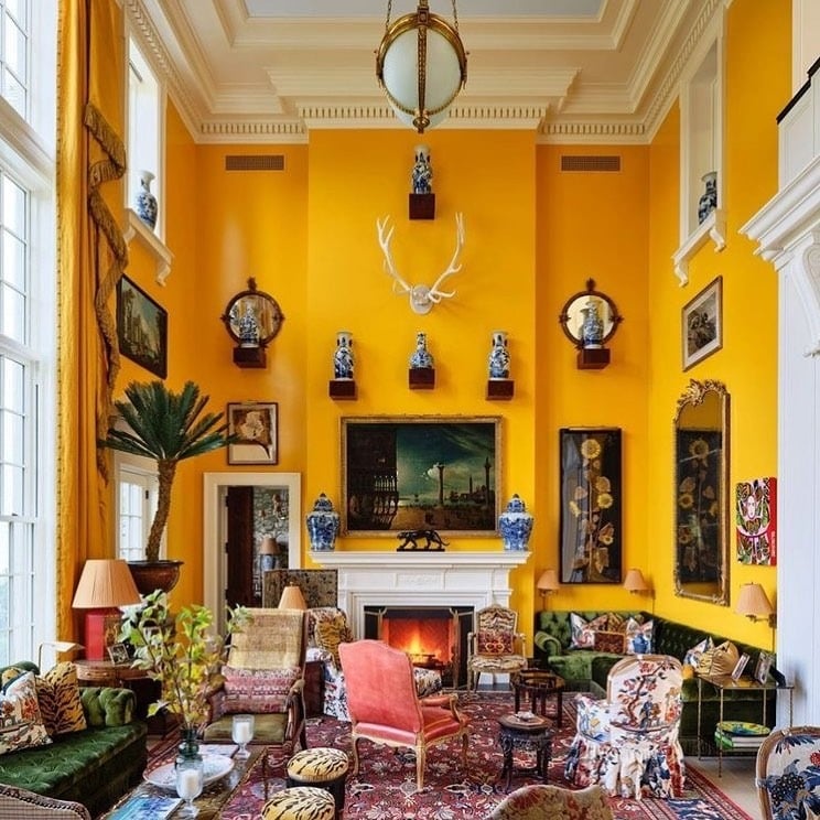 2. Grand Yellow Statement Walls with Classic Eclectic Furnishings - yellow living room ideas
