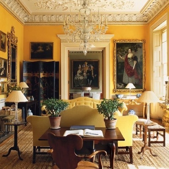 5. Heritage Yellow Walls with Antique Furnishings - yellow living room ideas