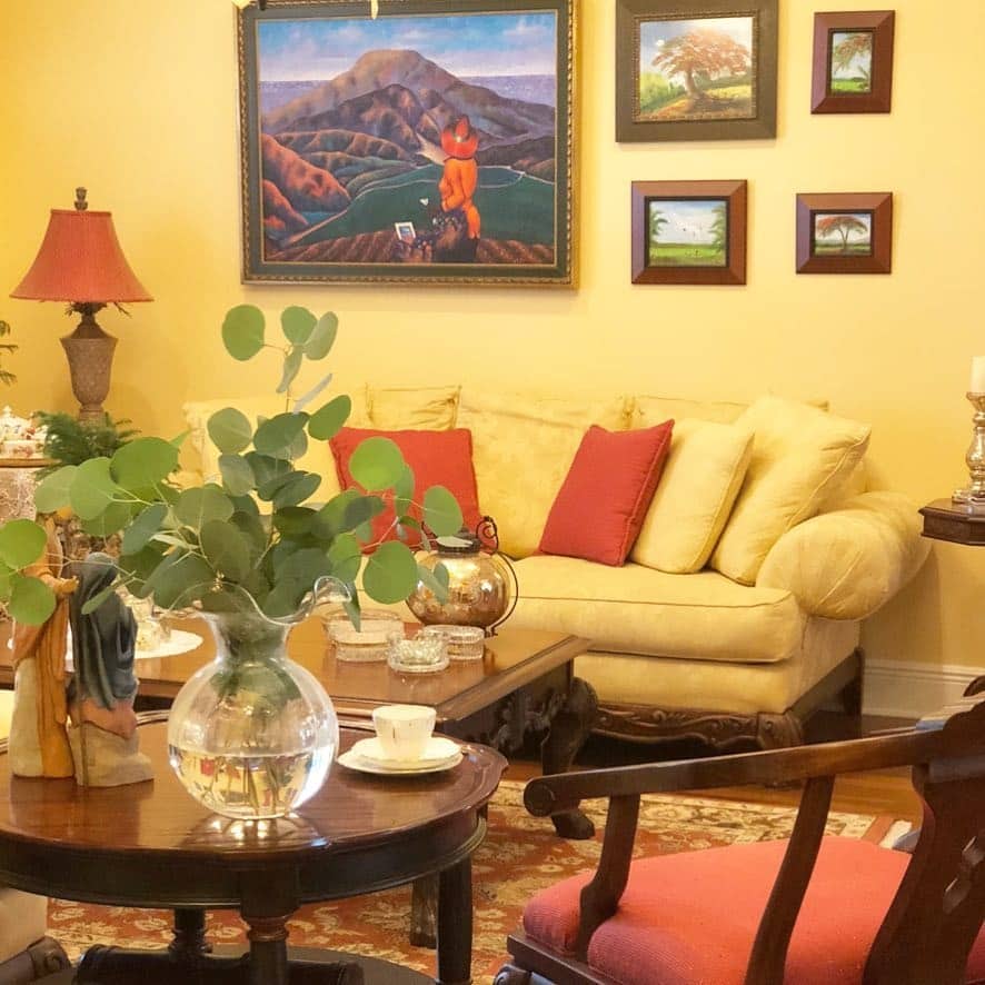 6. Refined Mustard Yellow with Classic Art Display - yellow living room ideas