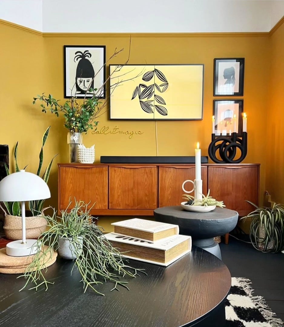 7. Modern Yellow Wall with Mid-Century Wood Accents - yellow living room ideas