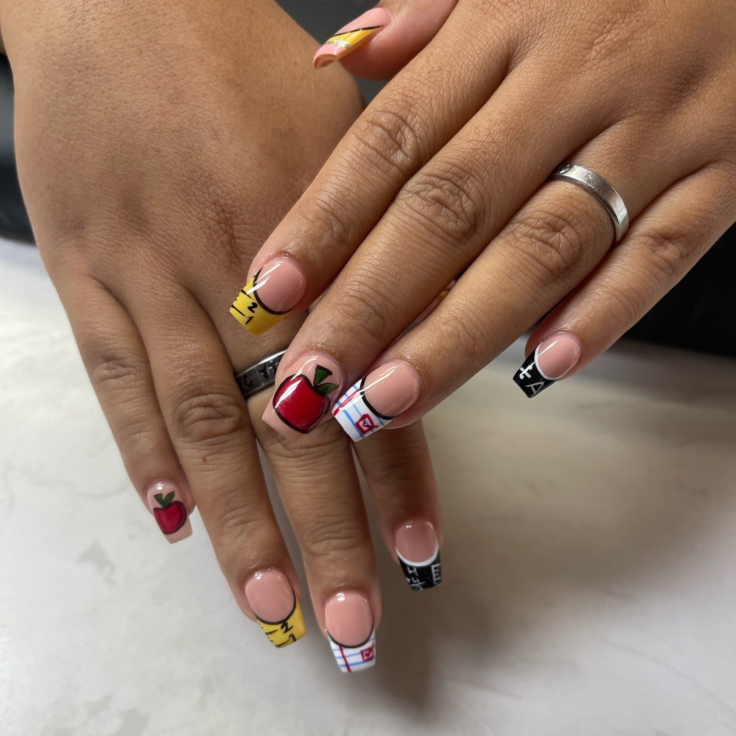 4. School-Themed French Tip Nails with Apple and Notebook Design - teacher nail ideas