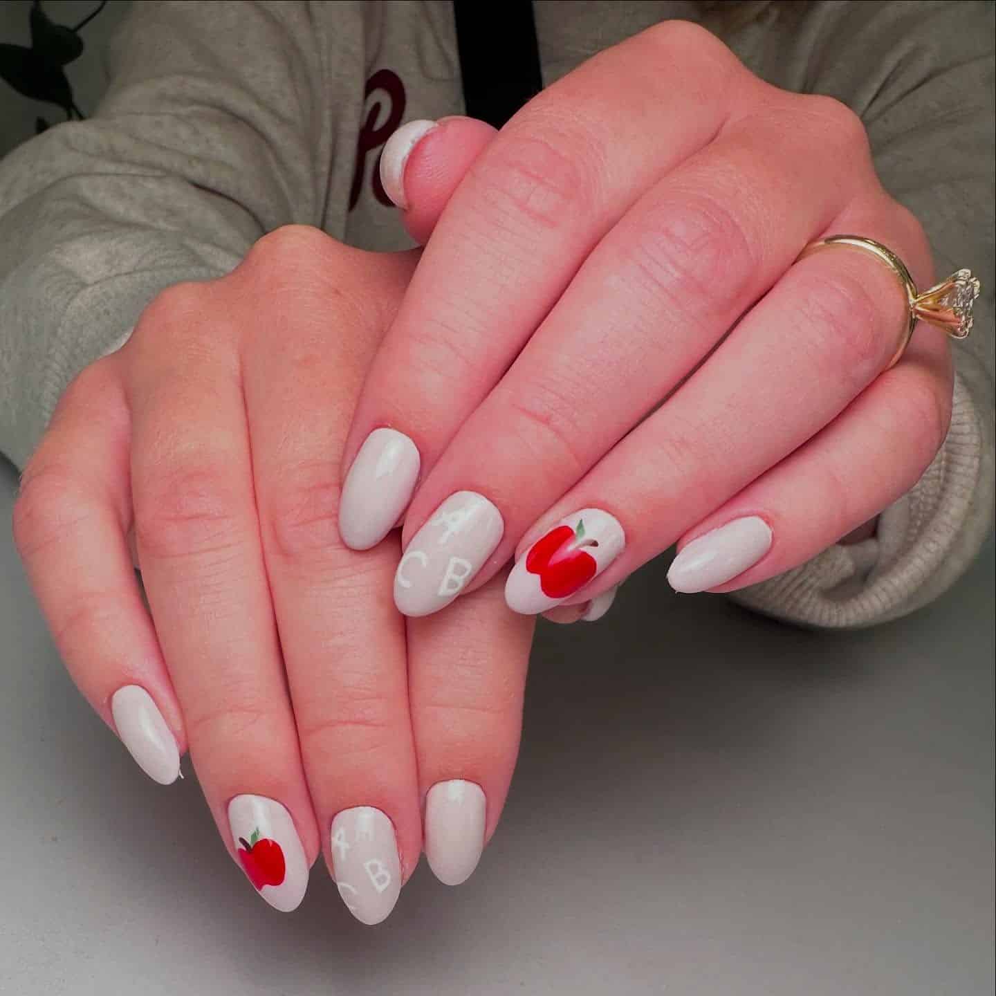 6. Minimal Apple & Lettering Nails in Soft White - teacher nail ideas