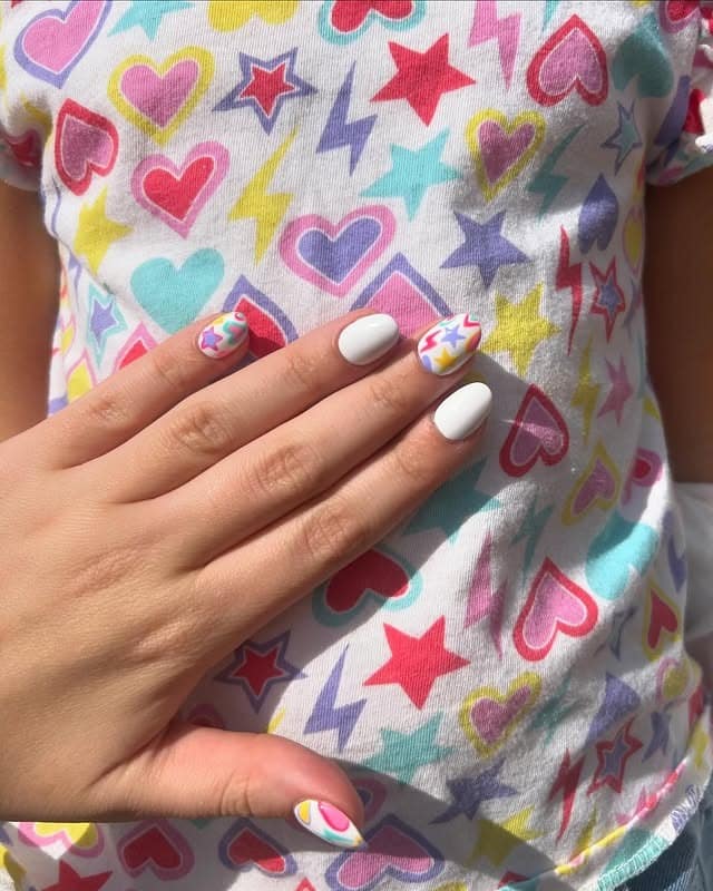 13. Pastel Star Pattern Nails in White with Multicolor Accents - teacher nail ideas