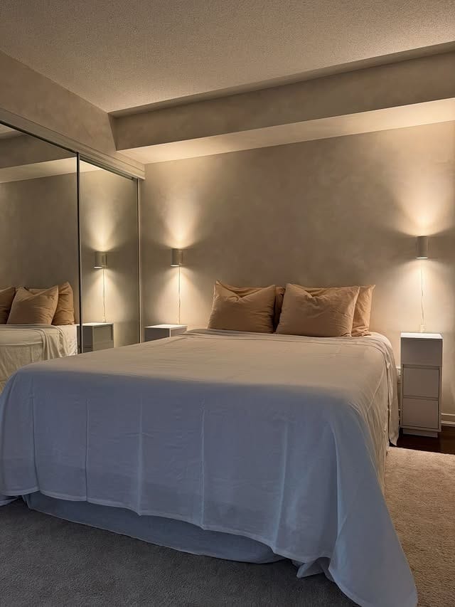 12. Warm Neutral Bedroom with Ambient Wall Lighting - small bedroom ideas