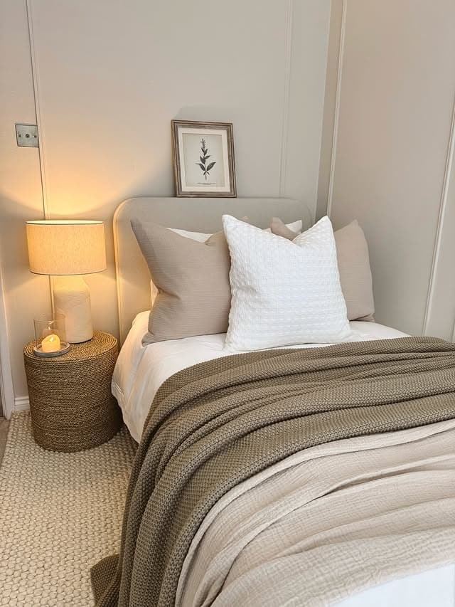 19. Cozy Neutral Bedroom with Textured Layers and Warm Lighting - small bedroom ideas