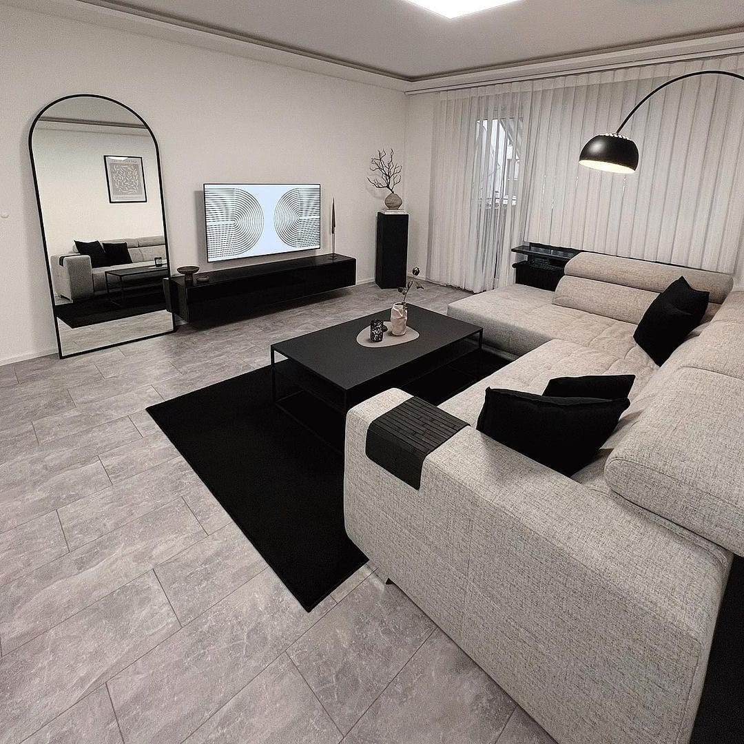 19. Contemporary Grey and Black Living Room with Mirror Feature - grey and black living room ideas