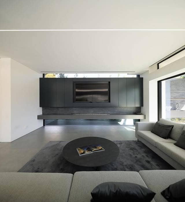 20. Ultra Minimal Grey Living Room with Floating Black Media Wall - grey and black living room ideas