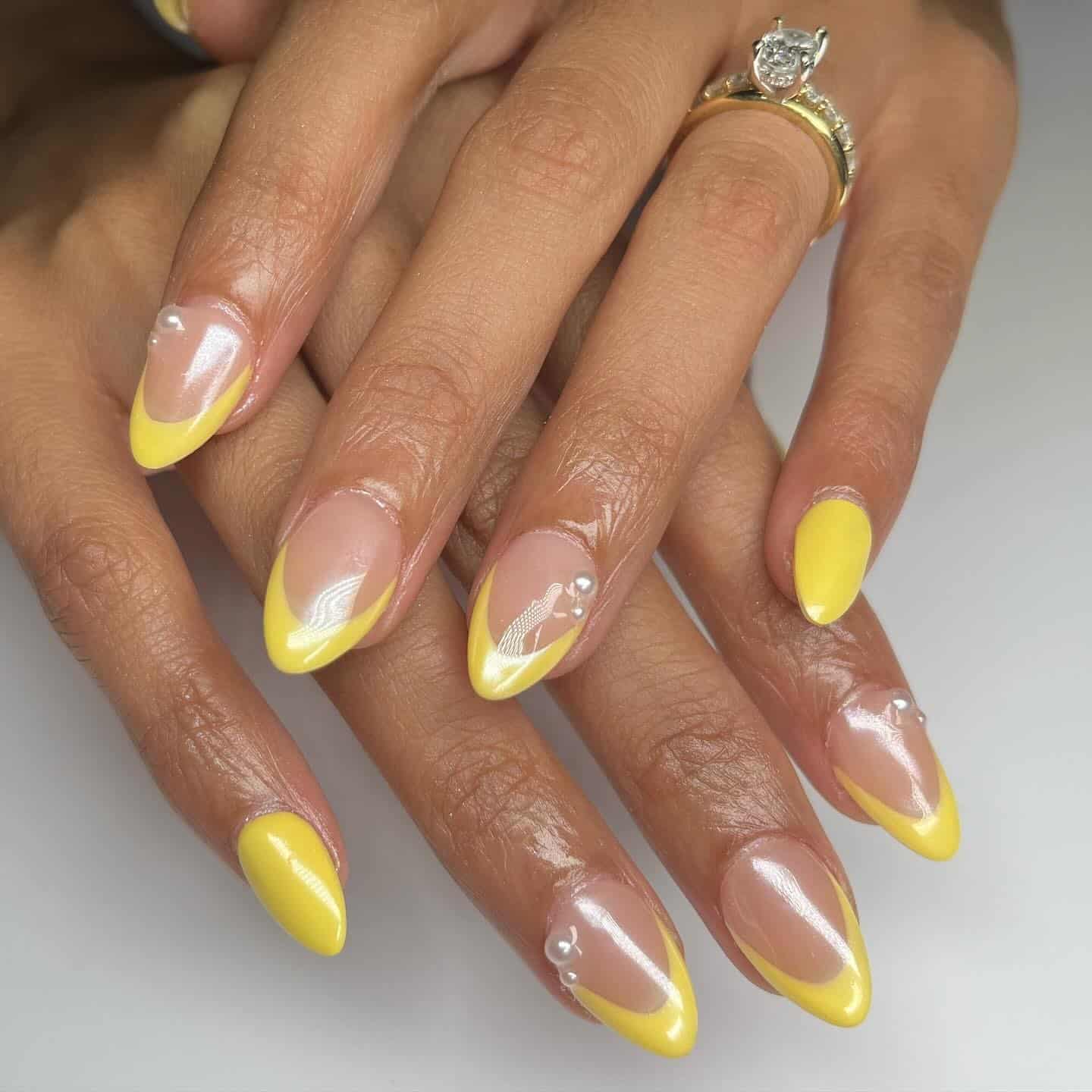 8. Glossy Yellow Micro French Almond Nails - pastel yellow nail ideas
