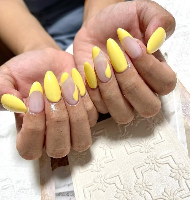 11. Pastel Yellow Abstract Almond Swirl Nails - pastel yellow nail ideas