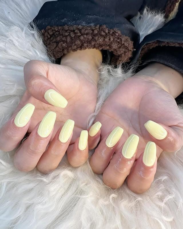 14. Glossy Pastel Yellow Medium Square Nails - pastel yellow nail ideas