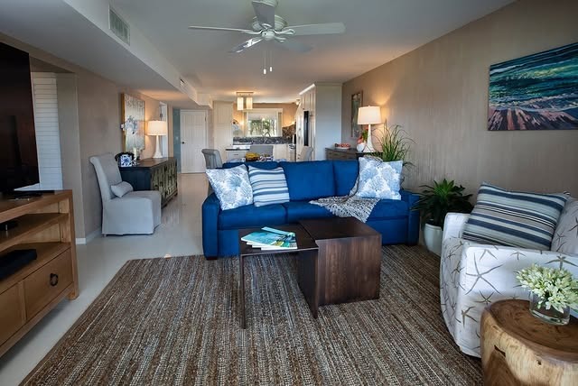 2. Coastal Blue Sofa with Neutral Open Layout - blue sofa living room ideas