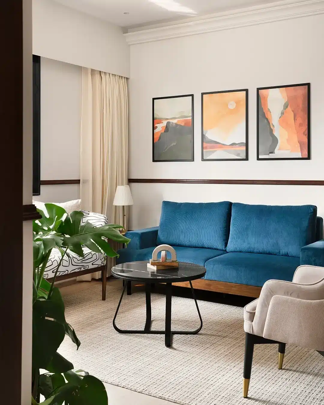 5. Mid-Century Blue Sofa with Art-Inspired Palette - blue sofa living room ideas