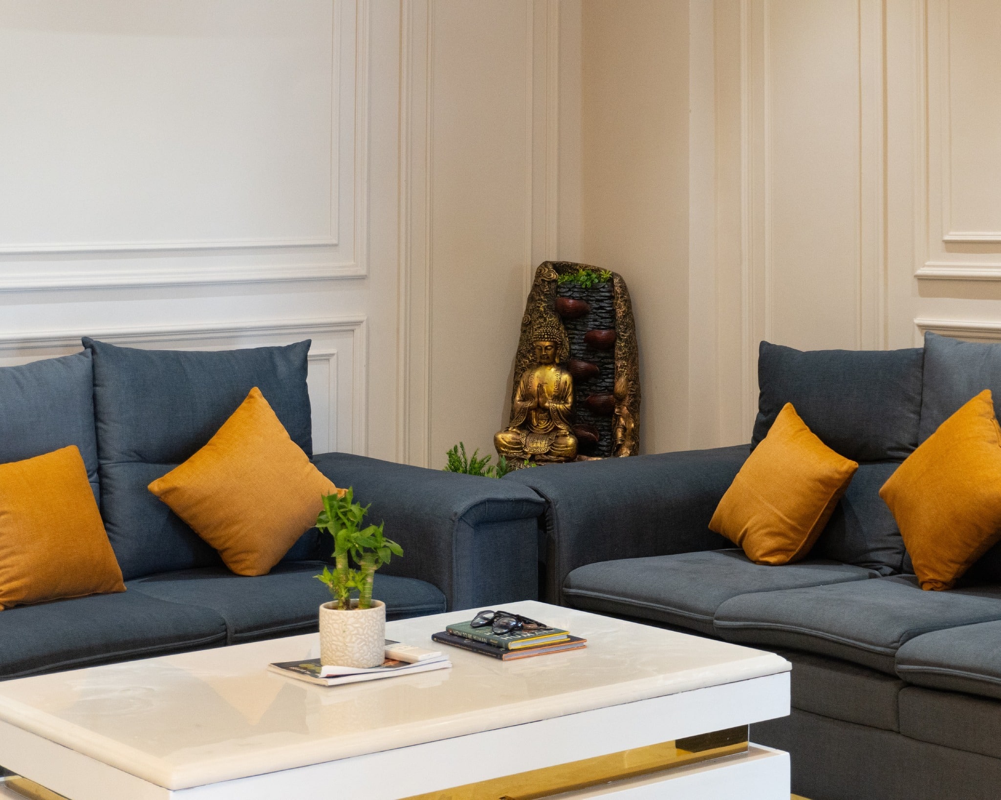 6. Charcoal Blue Sectional with Warm Accent Pillows - blue sofa living room ideas