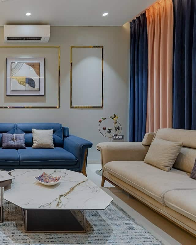 8. Modern Blue and Beige Sofa Pairing with Luxe Finishes - blue sofa living room ideas