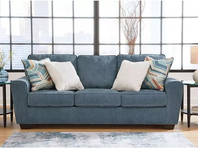 9. Casual Blue Fabric Sofa with Light-Filled Backdrop - blue sofa living room ideas