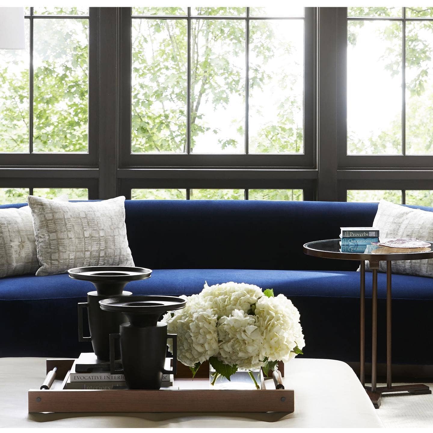 11. Navy Blue Sofa with Black Frame Window Contrast - blue sofa living room ideas